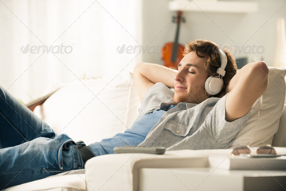 Guy with headphones on sofa