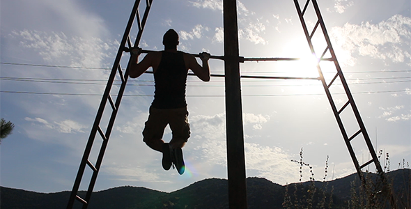 Strong Man doing Pull Ups under the Sun Strong Man doing Pull Ups under the Sun