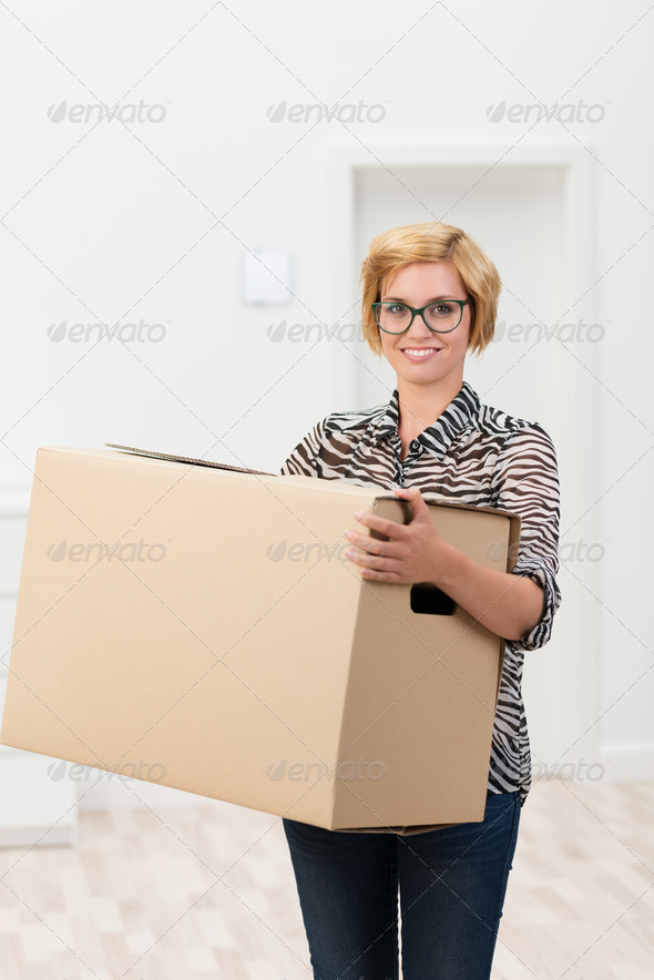 Pretty woman in glasses carrying a cardboard box