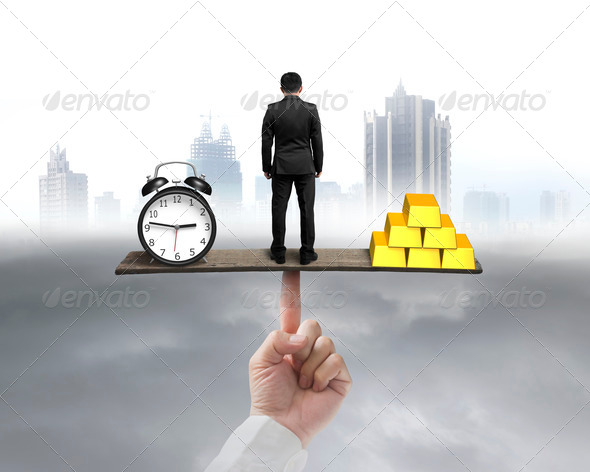 businessman standing between clock and gold balancing on seesaw (Misc) Photo Download