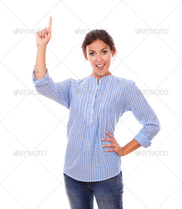 Hispanic lady pointing up while standing (Misc) Photo Download