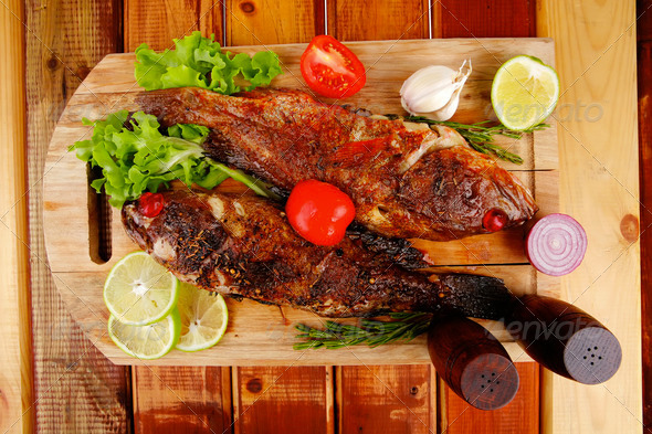 savory on wooden table: two fried fish (Misc) Photo Download