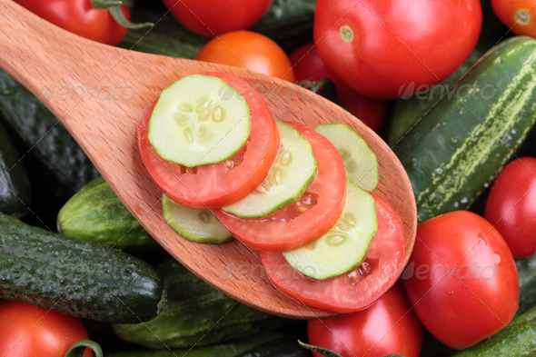 Slices of tomato and cucumber in a wooden spoon