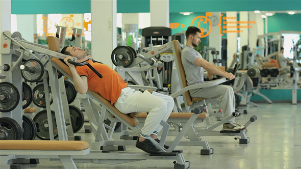Two Men Doing Exercise For The Chest Muscles Two Men Doing Exercise For The Chest Muscles