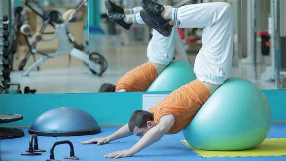 Young Man in a Red Shirt Doing Exercise Young Man in a Red Shirt Doing Exercise