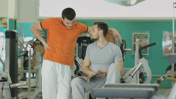 A Young Man With His Fitness Trainer A Young Man With His Fitness Trainer