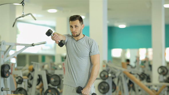 Young Man Doing Exercise With Dumbbells Young Man Doing Exercise With Dumbbells