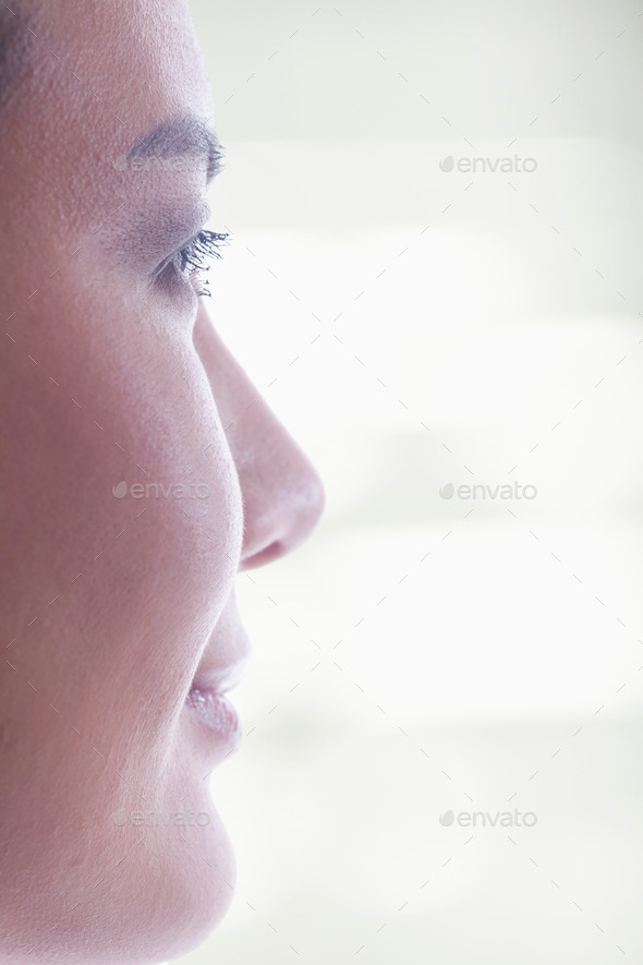 Side view of woman27;s face on bright background