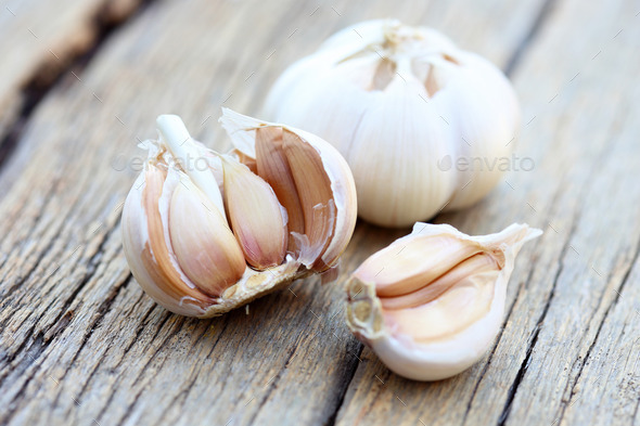Organic garlic on wood background