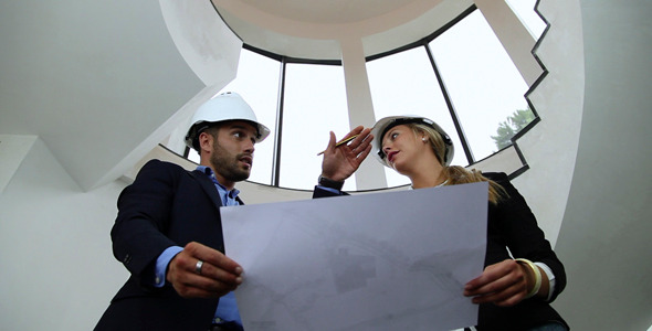 Architects Going Over Blueprints Architects Going Over Blueprints