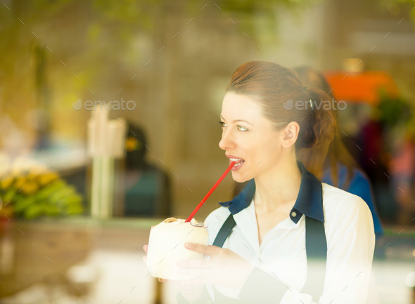 Healthy Woman enjoying her Smoothie in Juice Bar