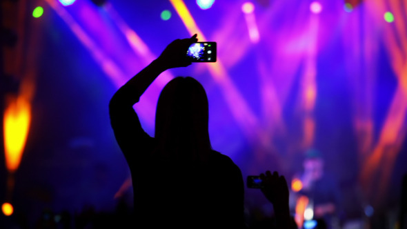 Girl with a Smartphone at a Rock Concert Girl with a Smartphone at a Rock Concert