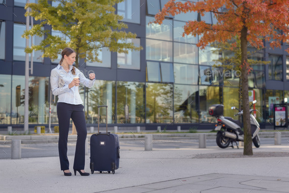 Woman with Suitcase Looking at Wristwatch (Misc) Photo Download