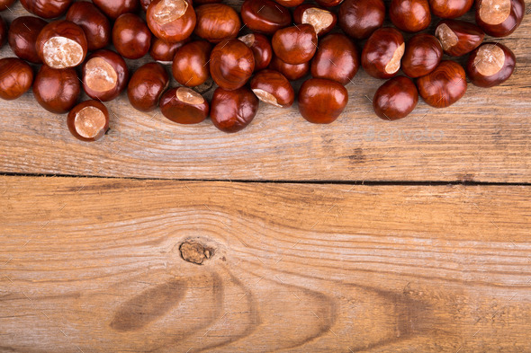 Autumn frame from chestnut on the old wooden background. Copy space. (Misc) Photo Download