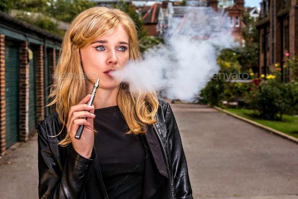 Pretty woman smoking an e-cigarette