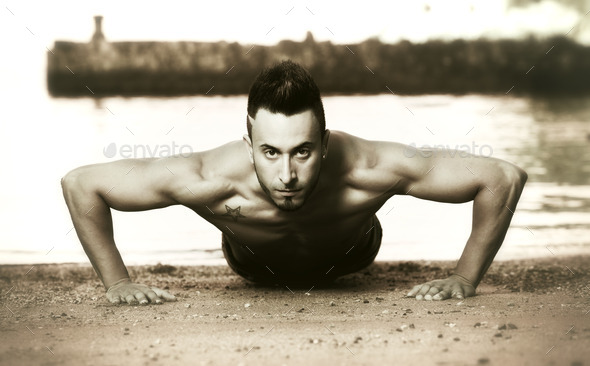 Handsome muscular man on the beach. (Misc) Photo Download