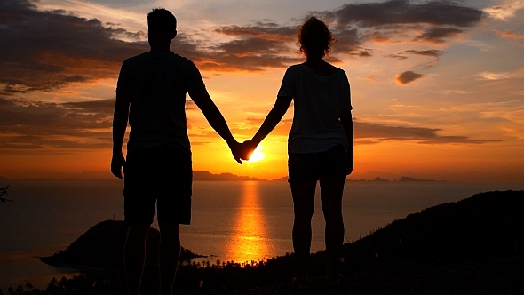 Couple on the Top of Mountain at Sunset Couple on the Top of Mountain at Sunset