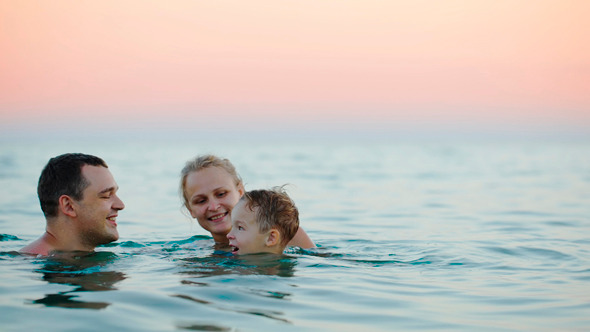 Young Parents With Son Bathing In Sea Young Parents With Son Bathing In Sea