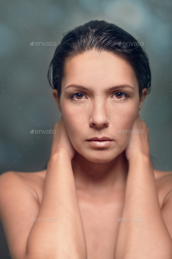 Portrait of Serious Woman with Hands Behind Neck