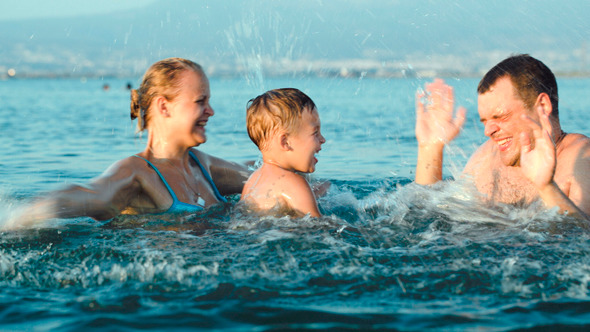 Happy Family Having Fun In Sea Water Happy Family Having Fun In Sea Water