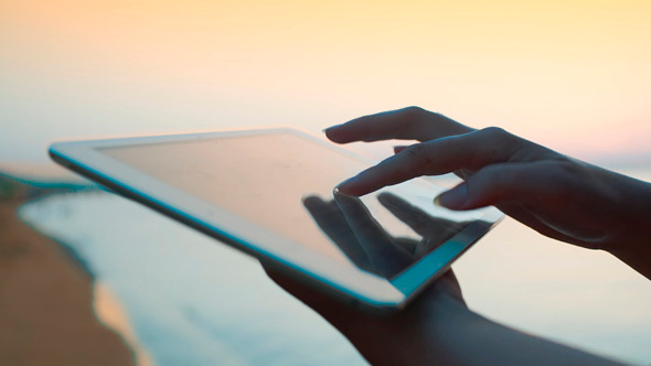 Female Hands Using Touch Pad By Sea Female Hands Using Touch Pad By Sea