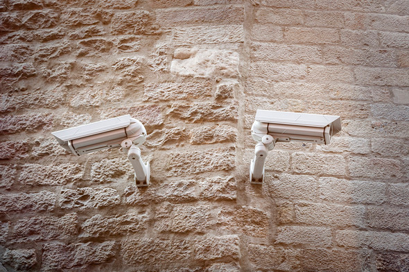 two observation cameras on a ancient natural stone wall (Misc) Photo Download