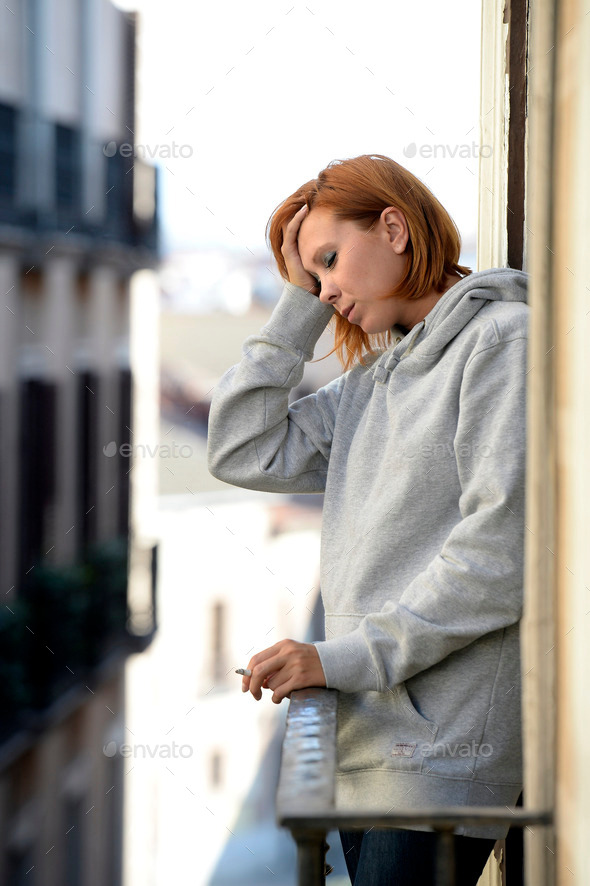 attractive woman suffering depression and stress outdoors at the balcony (Misc) Photo Download