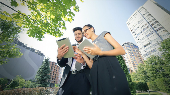 Business Couple Standing Together Work On The Tab Business Couple Standing Together Work On The Tab