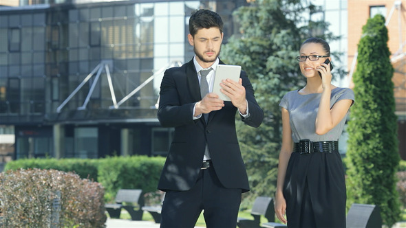 Couple Standing Together Work On The Tablet Couple Standing Together Work On The Tablet