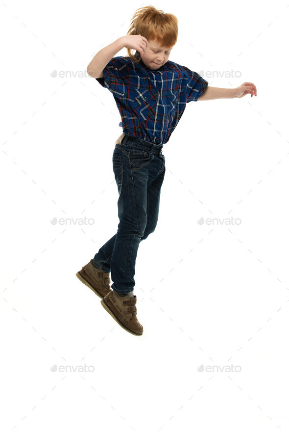 Little funny redhead boy in shirt and jeans jumping (Misc) Photo Download