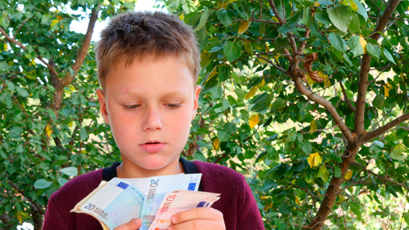 Boy Smelling Euro Notes 1 Boy Smelling Euro Notes 1