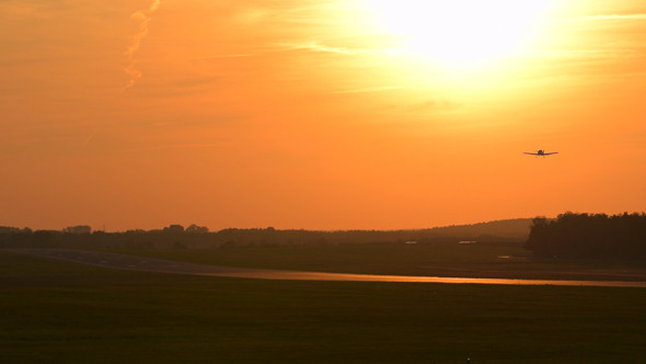 Plane Starting Against Sunset Sky Plane Starting Against Sunset Sky