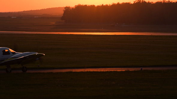 Plane Starting Against Sunset Sky Plane Starting Against Sunset Sky