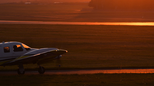 Plane Starting Against Sunset Sky Plane Starting Against Sunset Sky