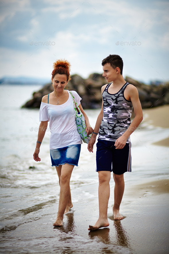 Mother and son walking on the beach