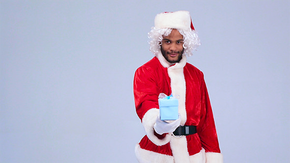 Santa Claus Giving a Gift in the Box for You Santa Claus Giving a Gift in the Box for You