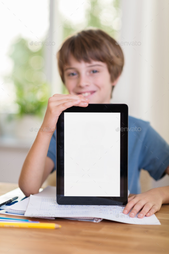 Happy young boy displaying his blank tablet