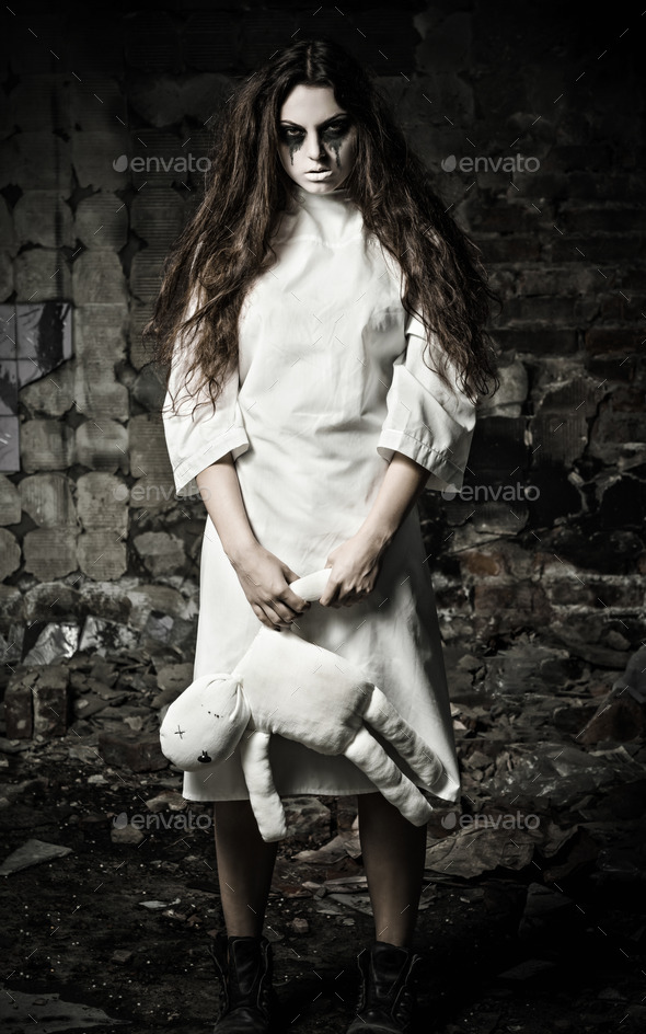 Horror style shot: scary monster girl with moppet doll in hands (Misc) Photo Download