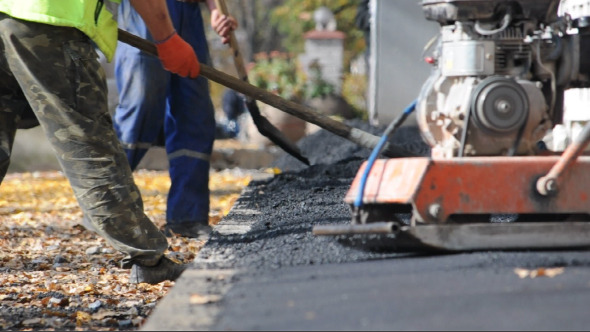 Asphalt Paver Applying Asphalt on the Way Asphalt Paver Applying Asphalt on the Way