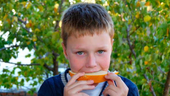 Young Boy Eating Healthy Melon Young Boy Eating Healthy Melon