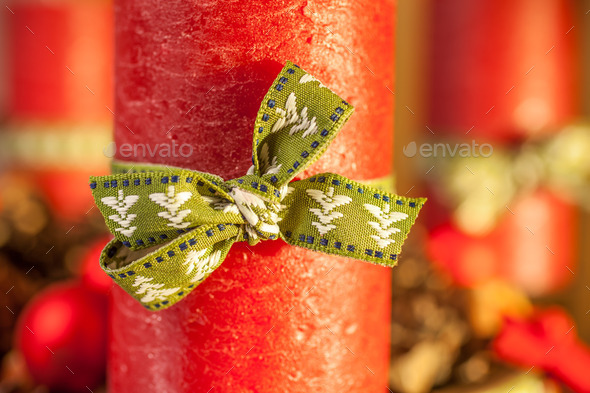 Red candle with green ribbon