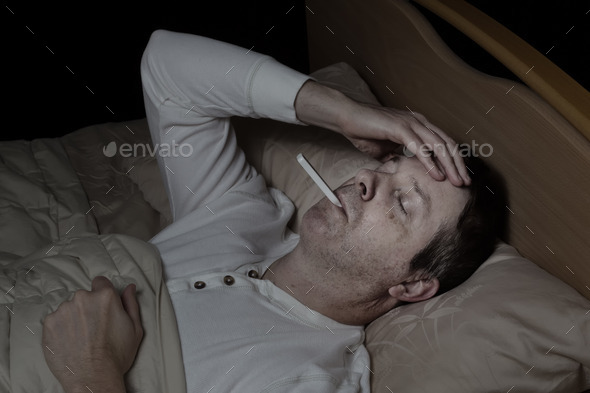 Mature man with high fever in bed