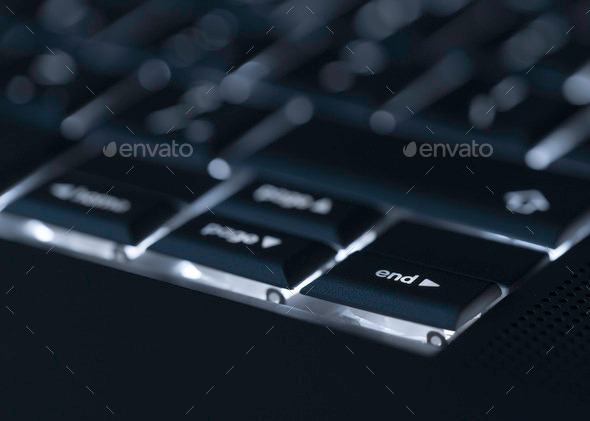 Closeup of backlit computer laptop keyboard selective focus on e (Misc) Photo Download