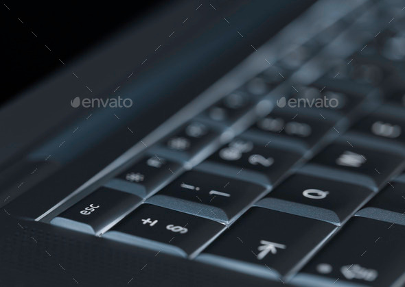 Closeup of backlit computer laptop keyboard selective focus on e (Misc) Photo Download