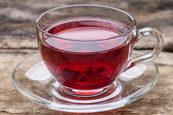 Red tea in glass cup on wooden table (Misc) Photo Download