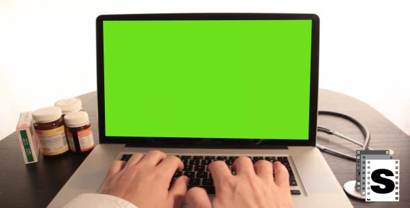 Doctor Typing On His Laptop Doctor Typing On His Laptop