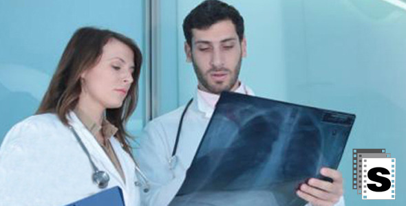 Doctors Examine An X-ray Doctors Examine An X-ray