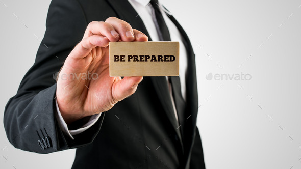 Businessman holding a card saying - Be Prepared (Misc) Photo Download
