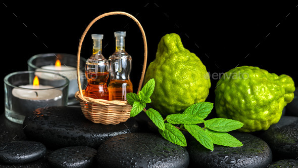 Aromatic spa concept of bergamot fruits, fresh mint, candles an