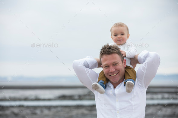 Dad and baby son at the beach.